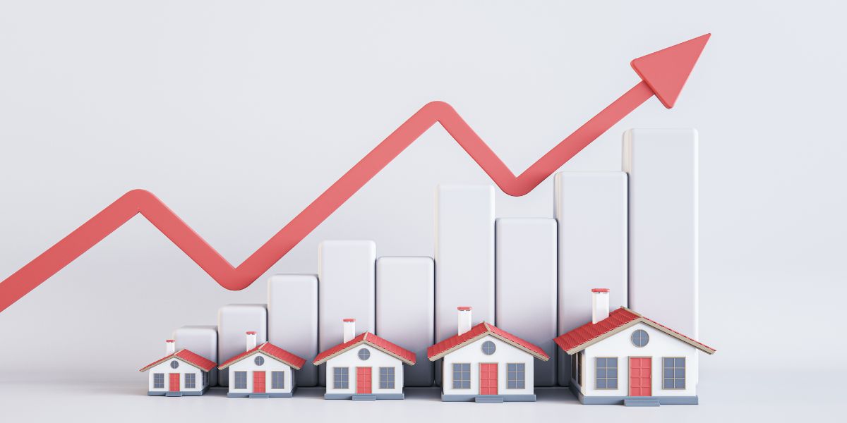 Illustration of miniature houses with a rising bar chart and an upward arrow indicating increasing property values.