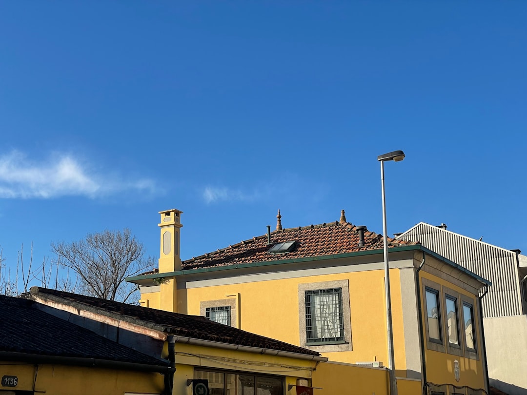 Close-up of a residential shingle roof under the bright, hot summer sun, illustrating the intense heat exposure common in ...