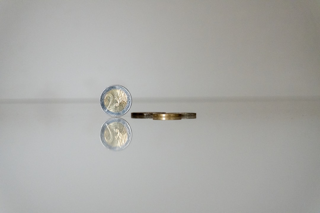 A modern, minimal balancing scale weighing a single coin on one side against a miniature model of a house on the other, illustrating the trade-off between commission savings and home value.